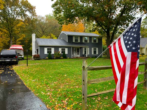 An American Flag in Front of Home with Homeowners Insurance in Bowling Green, OH