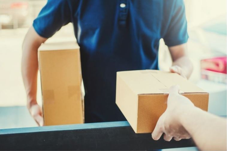 Man Handing Over a Box with Business Insurance in Waterville, OH