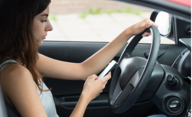Lady on Phone Sitting in Car with Car Insurance in Toledo, Napoleon, OH, Swanton, OH, Perrysburg, Bryan, OH, Montpelier, OH