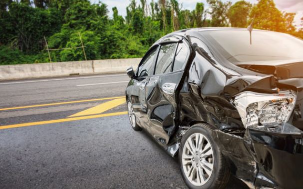 Black Car with Left Side all Dented with Auto Insurance in Swanton, OH