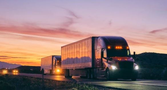 Trucks on Road with Sunset with Regional Trucking Insurance in Toledo, OH