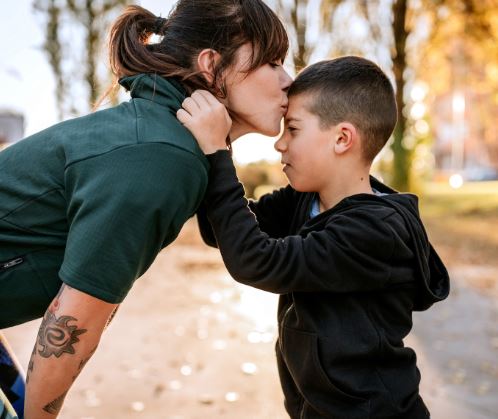 Mom Kissing Son's Forehead after working with an Insurance Agency in Swanton, OH