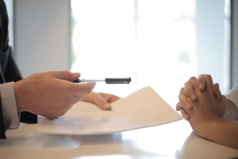 Two people discussing a policy inside of an Insurance Agency in Monclova, OH